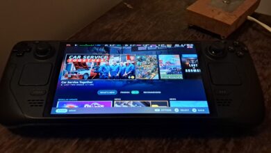 Valve Steam Deck OLED handheld showing the home screen on its front display