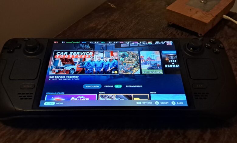 Valve Steam Deck OLED handheld showing the home screen on its front display